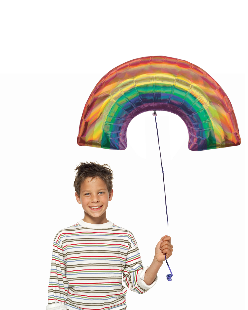 Child holding a large rainbow-shaped balloon against a white background