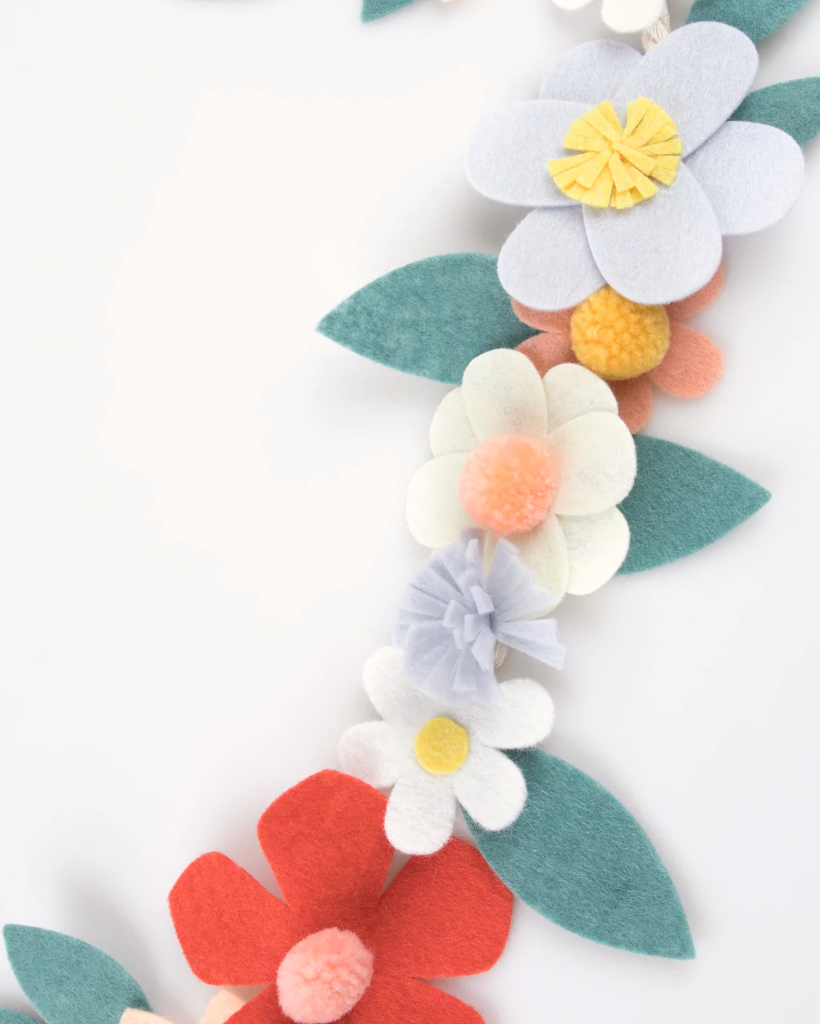 Colorful felt flowers and leaves make up this Meri Meri floral garland