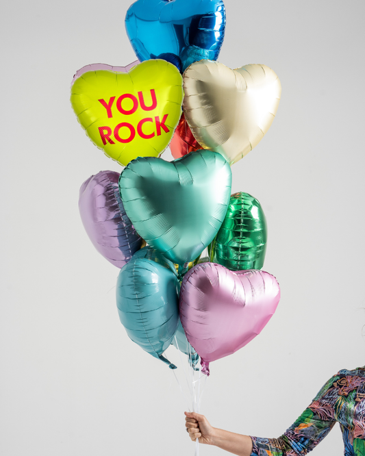 Colorful heart-shaped balloons with a 'YOU ROCK' message against a light gray background.