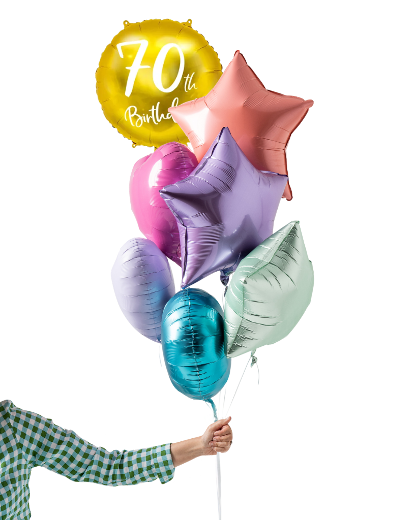 Colorful balloons including a '70th Birthday' balloon held by a person with a checkered shirt.