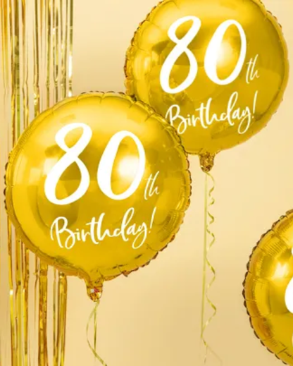 Gold '80th Birthday!' balloons on a beige background