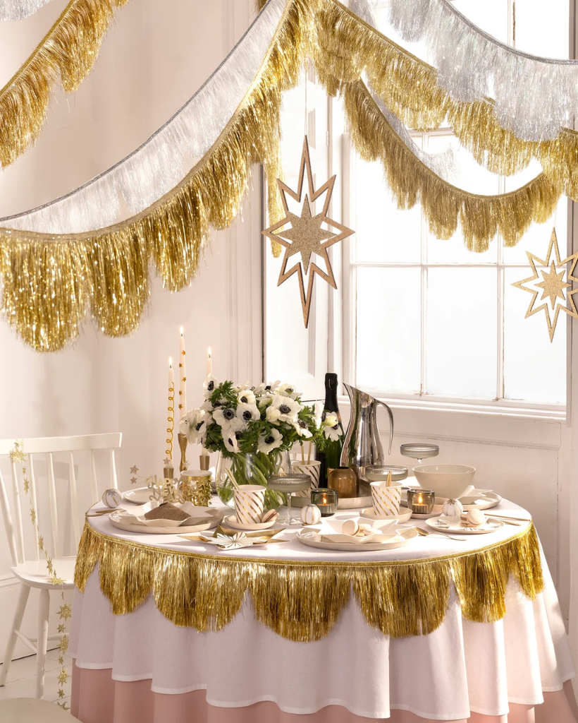 Decorative table setting with gold tinsel fringe garlands