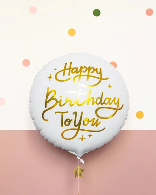 White balloon with gold 'Happy Birthday To You' text on a light pink background with colorful dots.