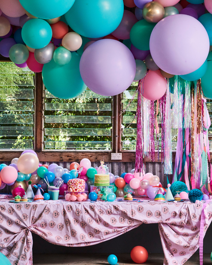mermaid theme party set up with mermaid balloon garland