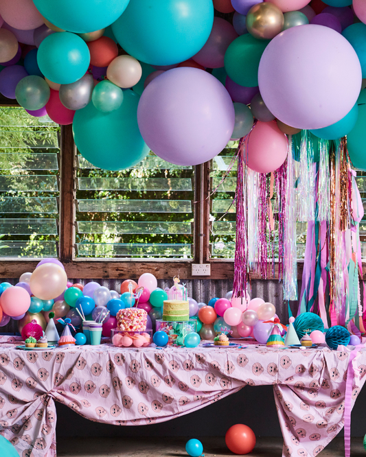 mermaid theme party set up with mermaid balloon garland