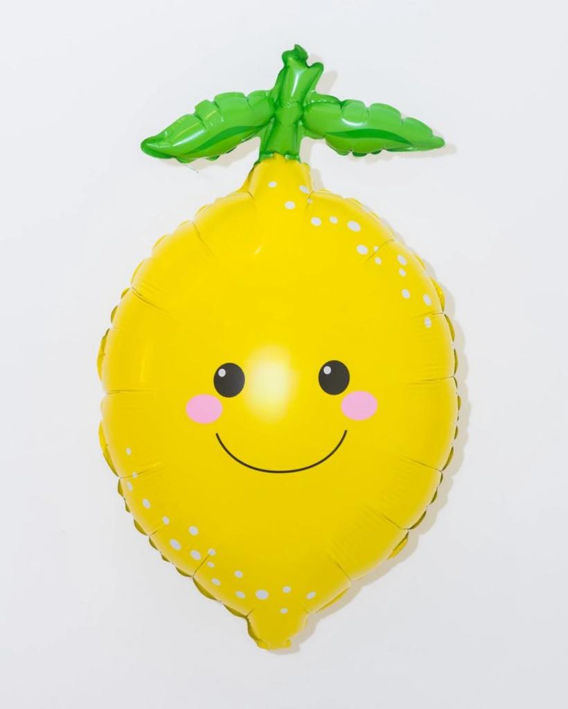 Yellow lemon-shaped balloon with a smiley face on a white background