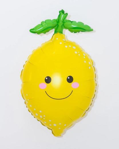 Yellow lemon-shaped balloon with a smiley face on a white background