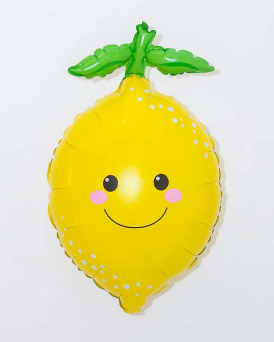 Yellow lemon-shaped balloon with a smiley face on a white background