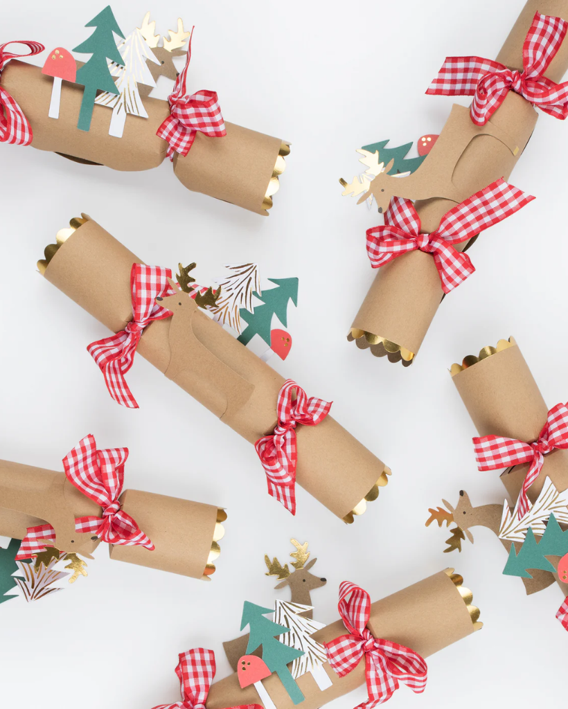 Decorative paper rolls with Christmas designs and ribbons on a white background