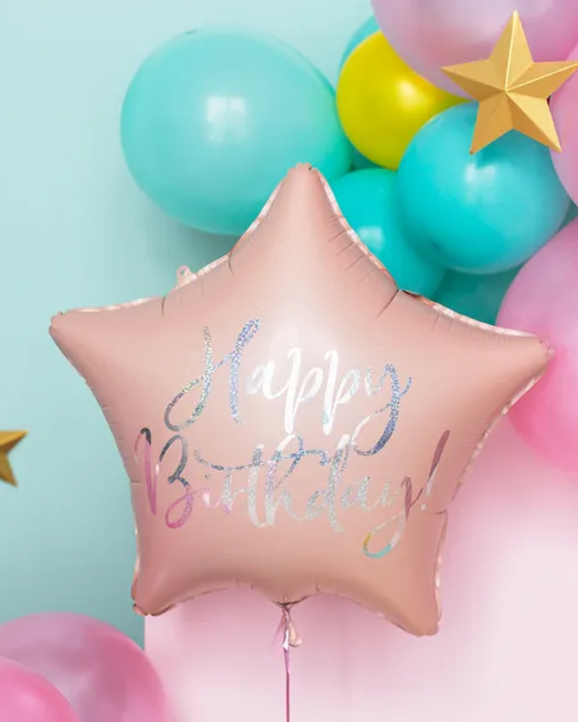 Star-shaped birthday balloon with 'Happy Birthday!' text among colorful balloons on a light blue background