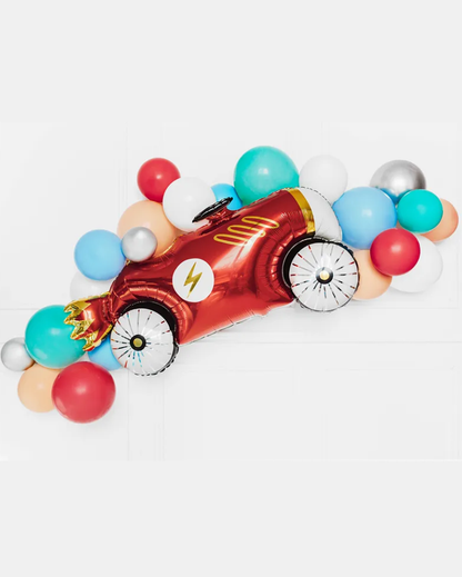 Colorful balloon arch shaped like a race car on a white background