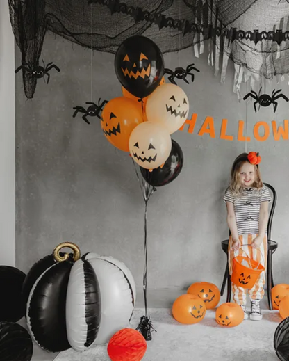 3D Black and white pumpkin-shaped balloon with a gold stem for Halloween