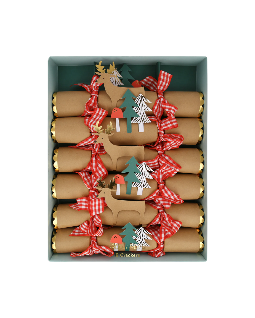 Box of Christmas crackers with reindeer and tree decorations on a white background