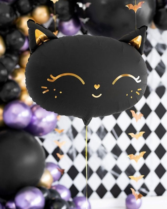 Black cat-shaped balloon with gold accents against a Halloween-themed background