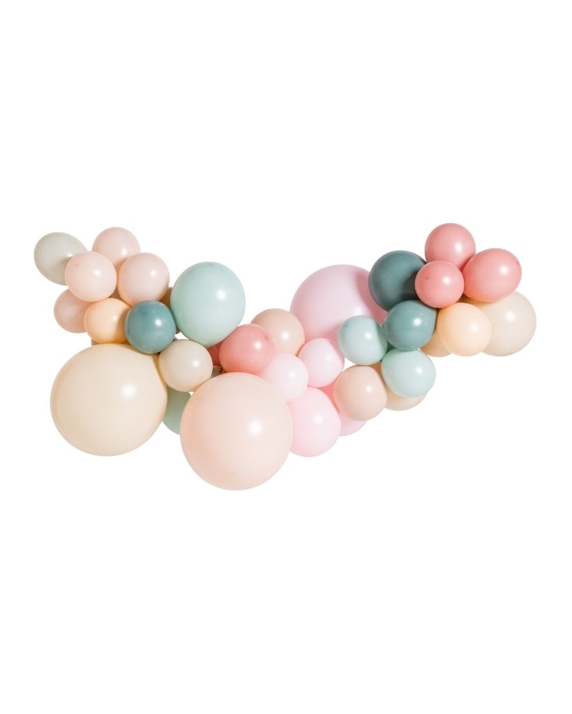 A balloon garland featuring a mix of round balloons in various sizes, colours including green, pink, peach and beige, arranged in an arch shape.