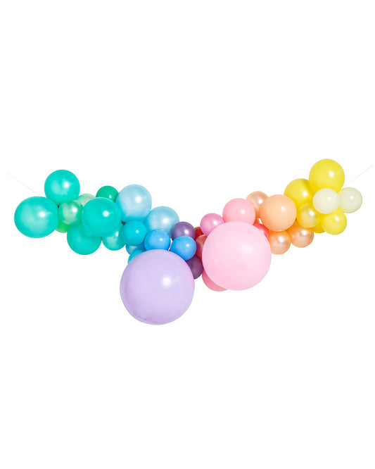 A garland of inflated pastel rainbow balloons arranged in a semi-circle, featuring various shades of green, blue, pink, and yellow.