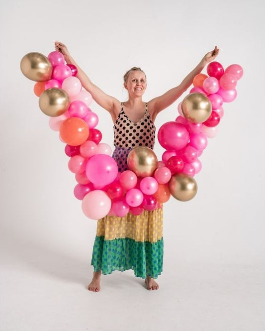 woman holding a small balloon garland